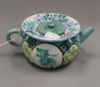 A Chinese painted terracotta teapot. 16 cm wide.