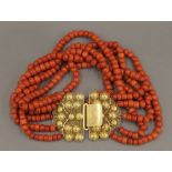 An 18 ct gold clasp and coral necklace. 36 cm long. 324 grammes total weight.