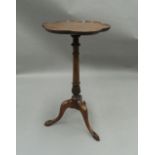 A mahogany occasional table with scalloped top, on tripod legs. 67 cm high, 35 cm diameter.