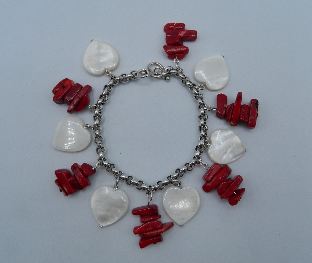 A silver coral and mother-of-pearl bracelet. 19 cm long.