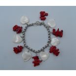 A silver coral and mother-of-pearl bracelet. 19 cm long.