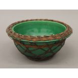 A 19th century Chinese pottery bowl with basket weave outer covering. 18.5 cm diameter.
