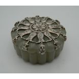 A silver mounted jade box, bearing Russian marks. 5.5 cm diameter.