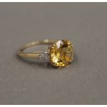 A 9 ct gold diamond and citrine ring. Ring Size N/O. 2.4 grammes total weight.