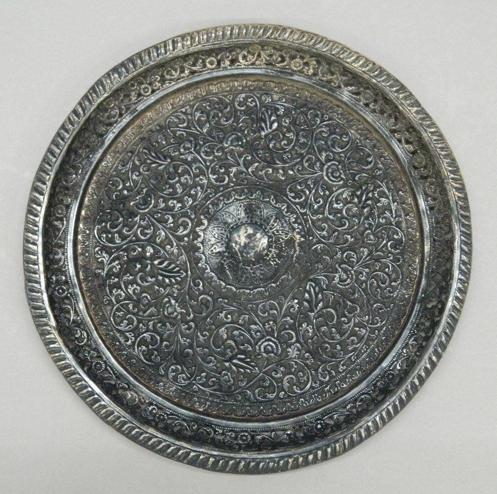 An Eastern embossed silver tray. 26 cm diameter. 11.9 troy ounces.