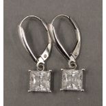 A pair of 14 K white gold earrings. Each 6 mm wide.