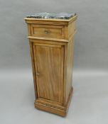 A 19th century mahogany marble topped pedestal cupboard. 98 cm high.