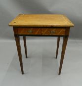 A 19th century Continental inlaid oak writing table. 61 cm wide.