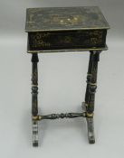 A 19th century lacquered work box. 31 cm wide.