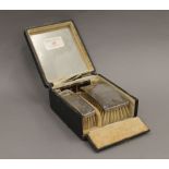 A cased set of silver brushes. The case 10.5 cm wide.