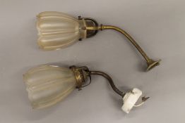 A pair of wall lights with glass shades. 24 cm high.