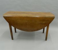 A 19th century French cherrywood drop leaf table. 135 cm long.