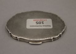 A silver compact. 9 cm wide. 87 grammes total weight.