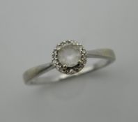 A 9 ct white gold diamond and white zircon cluster ring. Ring size N.