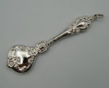 A silver rattle. 10 cm high.