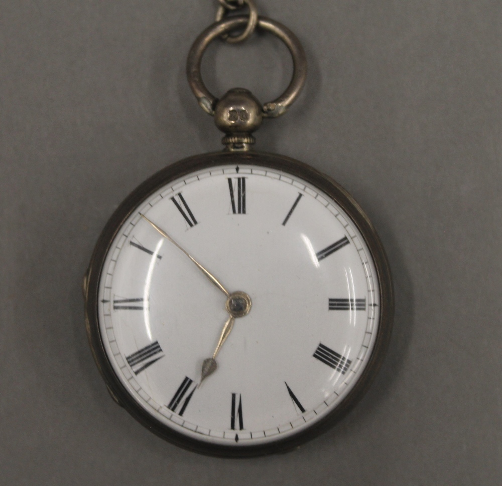 Two 19th century silver pocket watches on chains and a brass pocket watch case. - Image 6 of 12