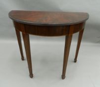 A flame mahogany demi-lune side table. 95 cm wide.
