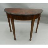 A flame mahogany demi-lune side table. 95 cm wide.