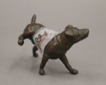 A bronze model of a dog cocking his leg. 6.5 cm long.