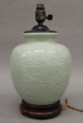A Chinese celadon pottery lamp. 37 cm high.