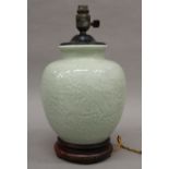 A Chinese celadon pottery lamp. 37 cm high.