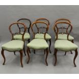 A set of six Victorian walnut balloon back dining chairs.