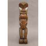A South Seas, possible Maori, stylized figural carving with abalone shell eyes. 35 cm high.