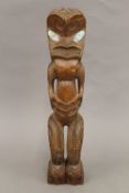 A South Seas, possible Maori, stylized figural carving with abalone shell eyes. 35 cm high.