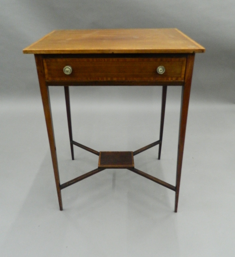 An Edwardian crossbanded mahogany single drawer side table. 58 cm wide.