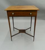 An Edwardian crossbanded mahogany single drawer side table. 58 cm wide.