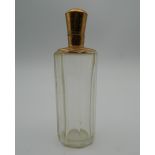 An 18 ct gold topped scent bottle. 9 cm high.