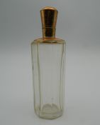 An 18 ct gold topped scent bottle. 9 cm high.