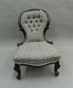 A Victorian walnut framed nursing chair. 56 cm wide.