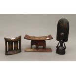 Two African tribal head rests and a carved figure. The latter 29 cm high.