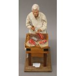 A model of a butcher. 31 cm high.