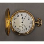 A gold plated pocket watch. 4.5 cm diameter.