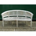 A curved wooden garden bench