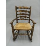 An oak ladder back rocking chair