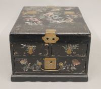 A Chinese lacquered table cabinet. 24 cm wide.