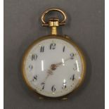 An 18 ct gold ladies fob watch. 2.5 cm diameter. 15.6 grammes total weight.