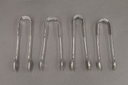Four pairs of 19th century silver sugar tongs. The largest 15 cm long. 164.2 grammes.