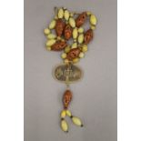 A Chinese nut and coin necklace