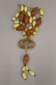 A Chinese nut and coin necklace