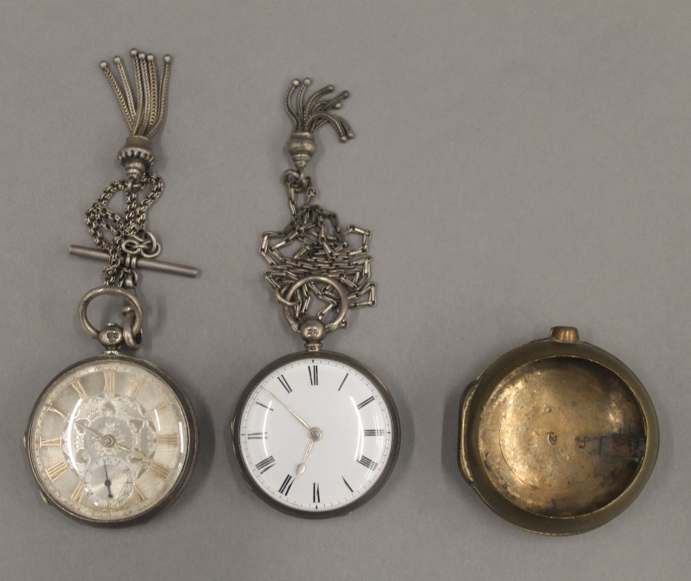 Two 19th century silver pocket watches on chains and a brass pocket watch case.