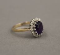 A 9 ct gold diamond and amethyst ring. Ring Size P. 3.1 grammes total weight.