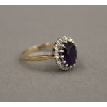 A 9 ct gold diamond and amethyst ring. Ring Size P. 3.1 grammes total weight.