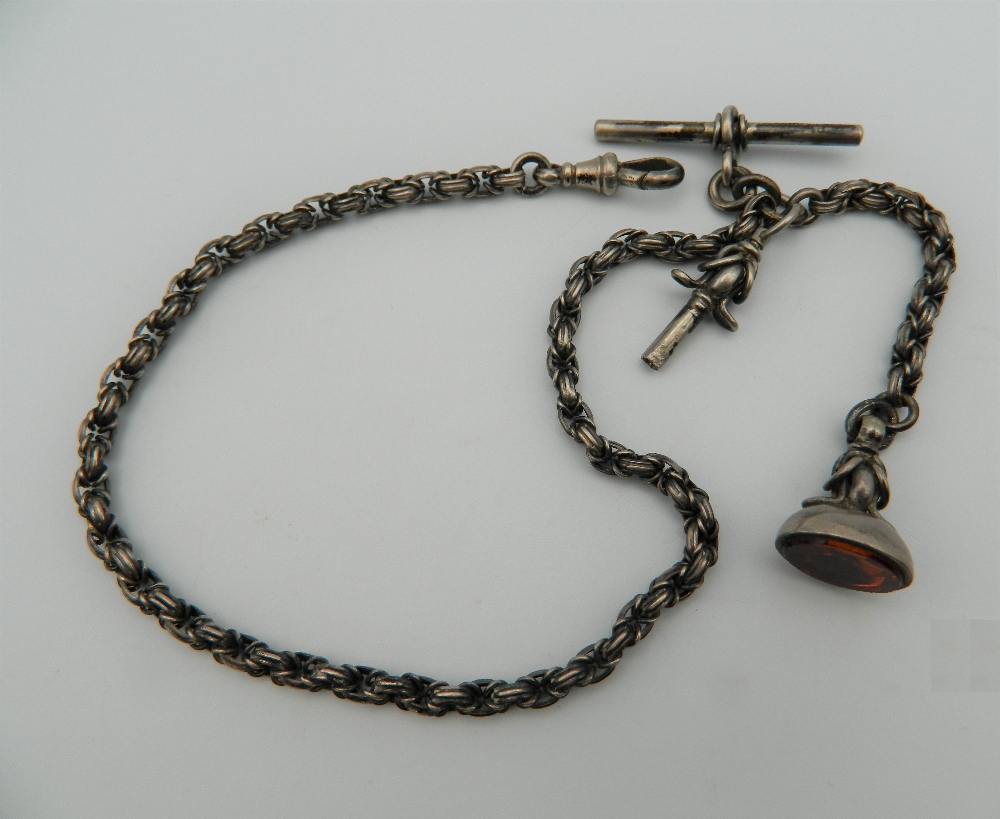 An unmarked silver watch chain, together with key and fob. 34 cm long.