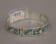 A silver and turquoise bracelet. 47.6 grammes.