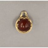 A 9 ct gold and agate fob. 2 cm high.