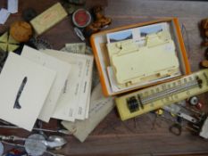 A wooden tray containing various collectable items.